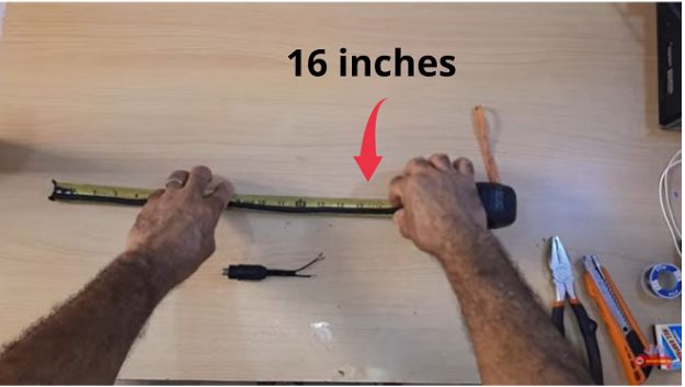 man using tape measure for a 16-inches coaxial cable