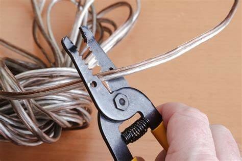 man cutting a wire with clipper