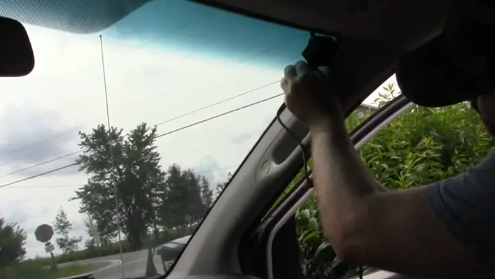man installing antenna on his car