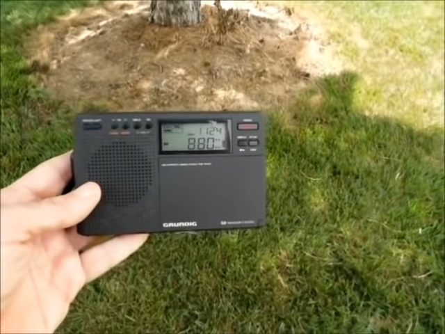 man's hand holding a radio