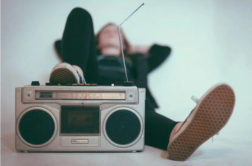 teenage boy stepping one foot at a radio with antenna up