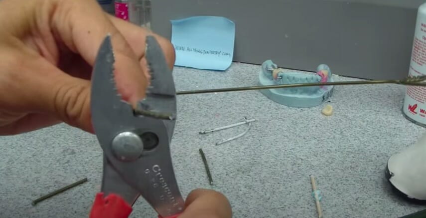 cutting iron coat hanger using plier